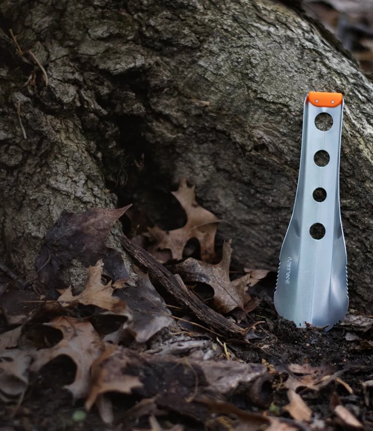 boglerco trowel leaning against tree root
