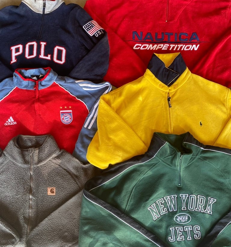 a pile of vintade branded clothes