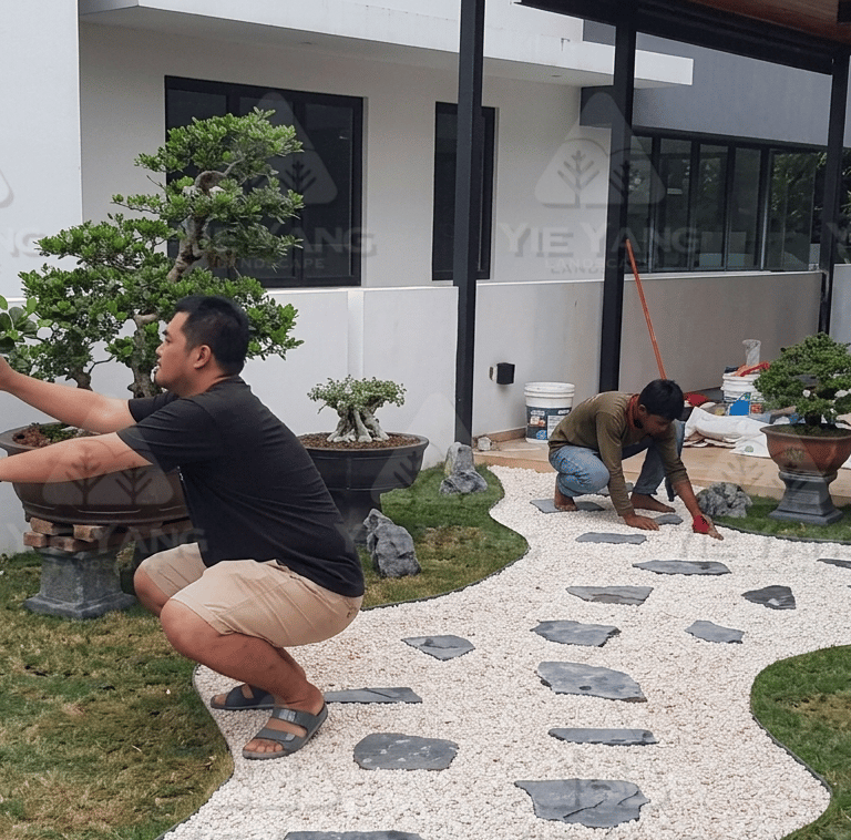 Bonsai garden installation at Laman Granview Selangor featuring potted trees and white gravel path.