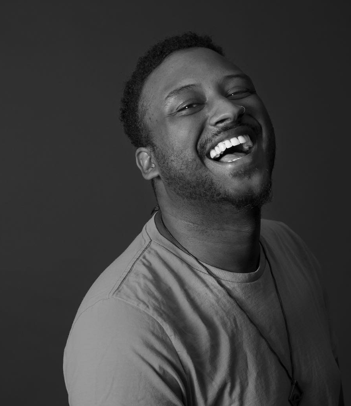 edwin bodney LA based spoken word poet laughs in black and white photo