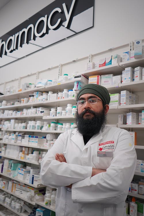 a man in a pharmacy office with a beardless man in a pharmacy