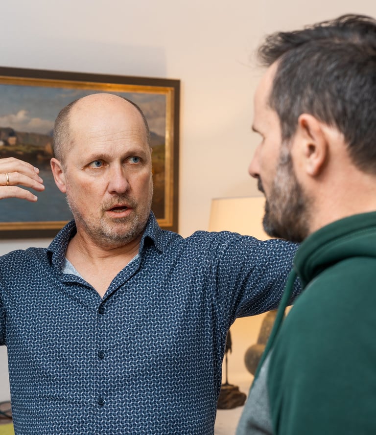 Singing teacher is correcting the pose of his student.