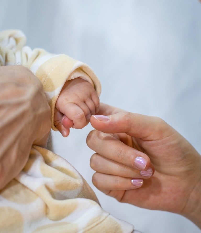 a baby's hand holding a baby's finger