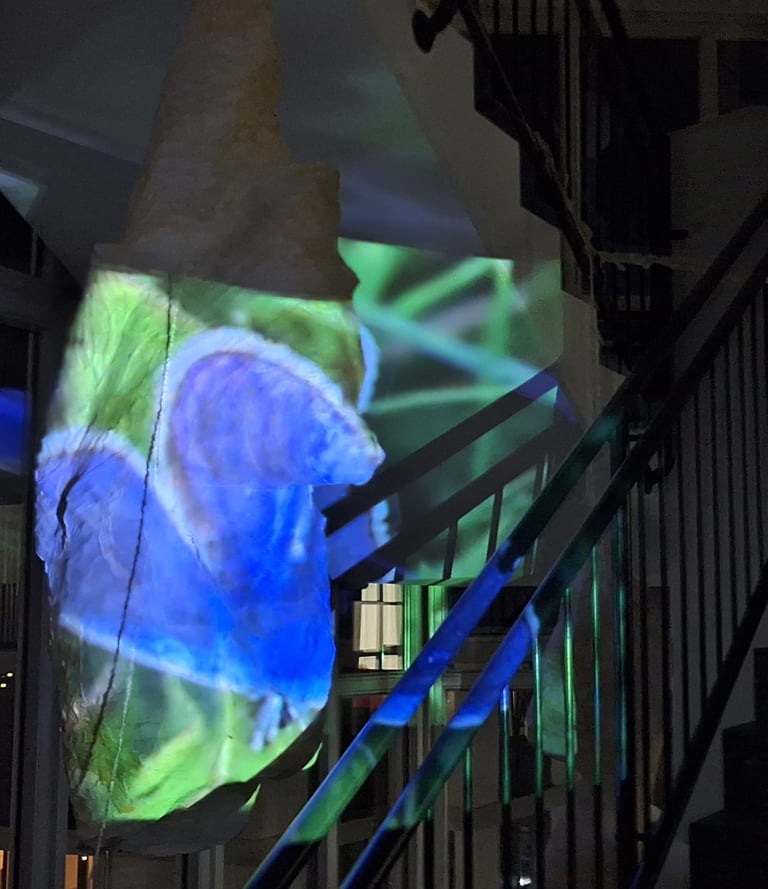 a large blue and green light bulb with a large blue buterfly