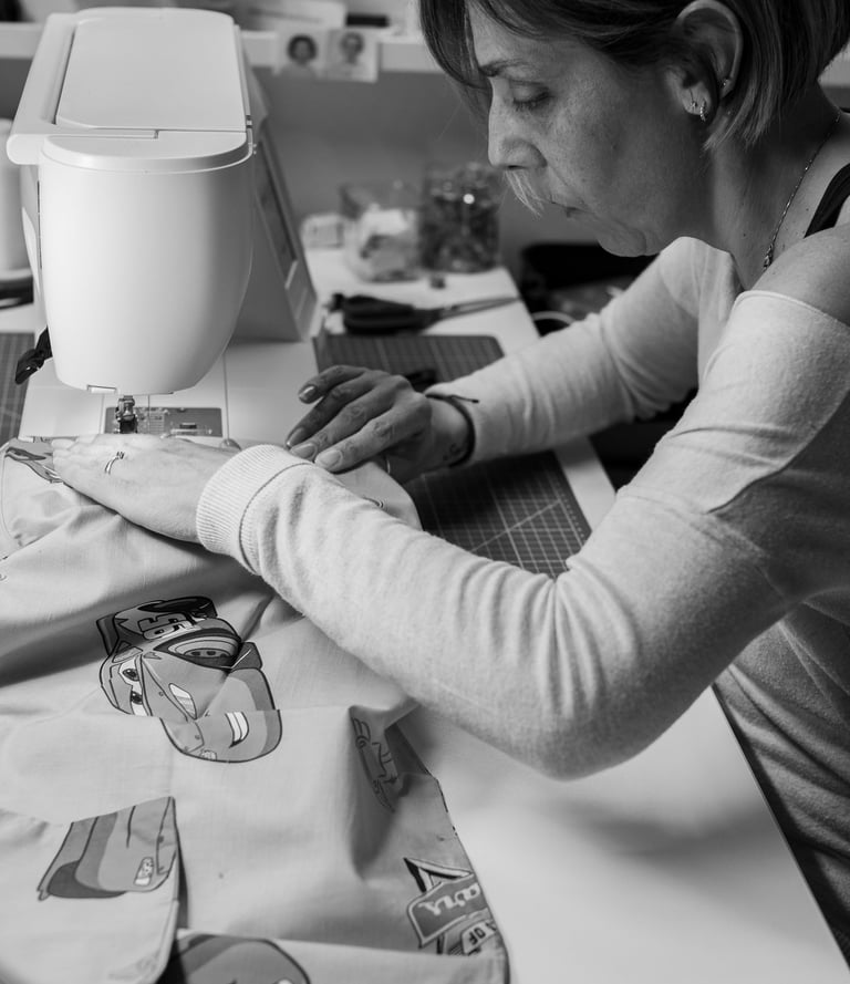 a woman is sewinging a dress on a sewing machine