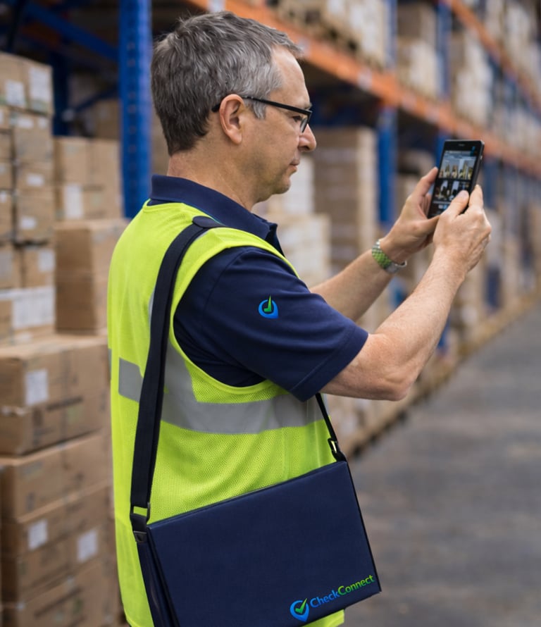 Man attending a warehouse and taking photos for the client