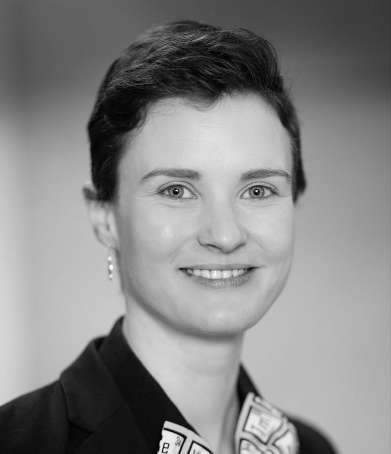 a woman in a suit and tie smiling