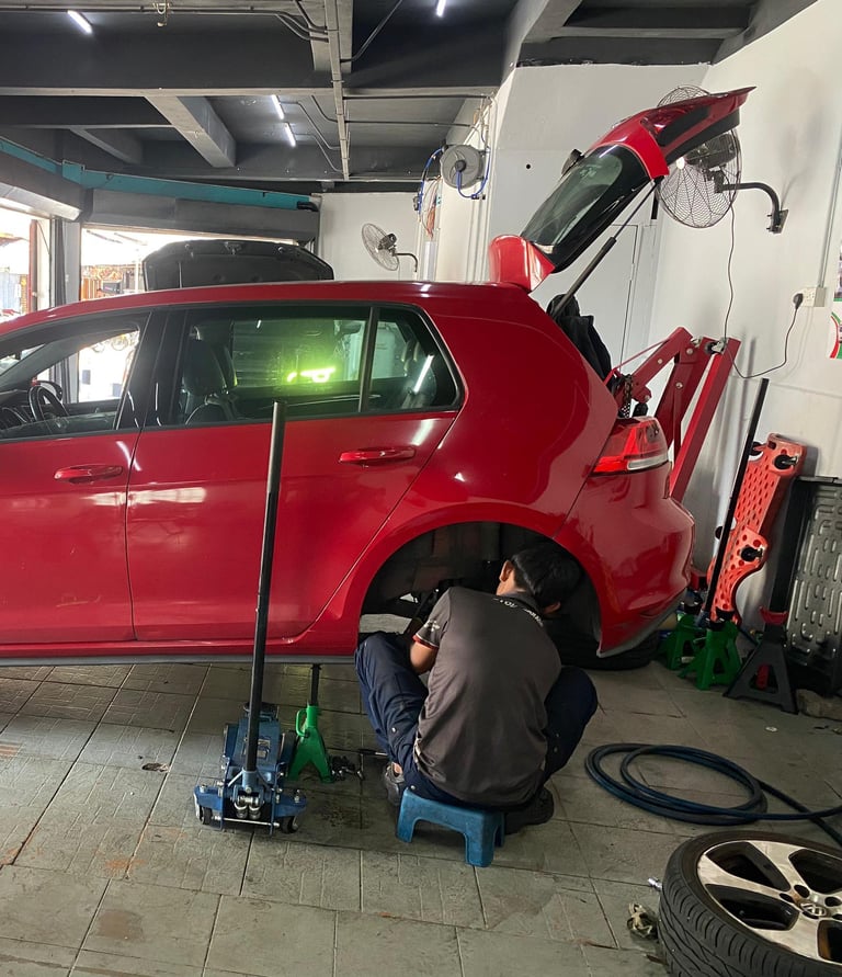 a man working on a car in a garage