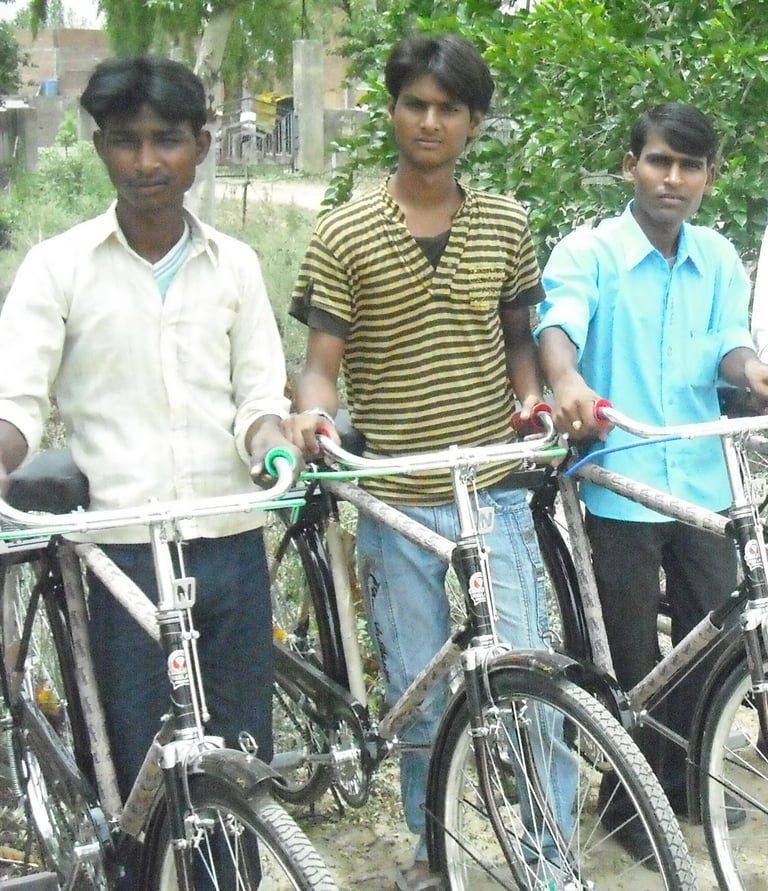 a group of men standing around a row of bicycles