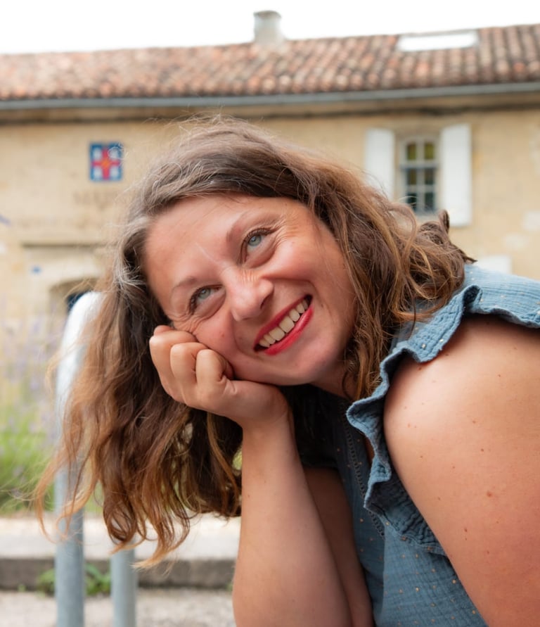a woman with a blue shirt and a blue jean. Amandine Lebrun massage therapist tantric