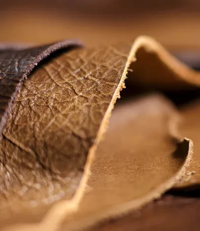 a close up of a leather bag with a leather strap