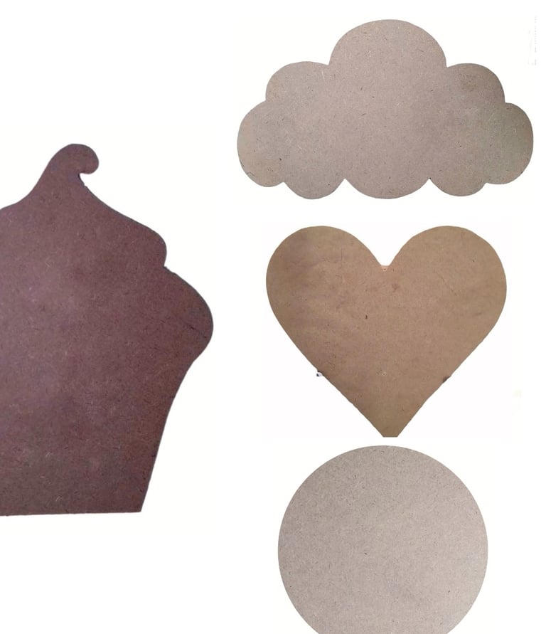 a cupcake cut out of cardboard with a heart shaped cookie