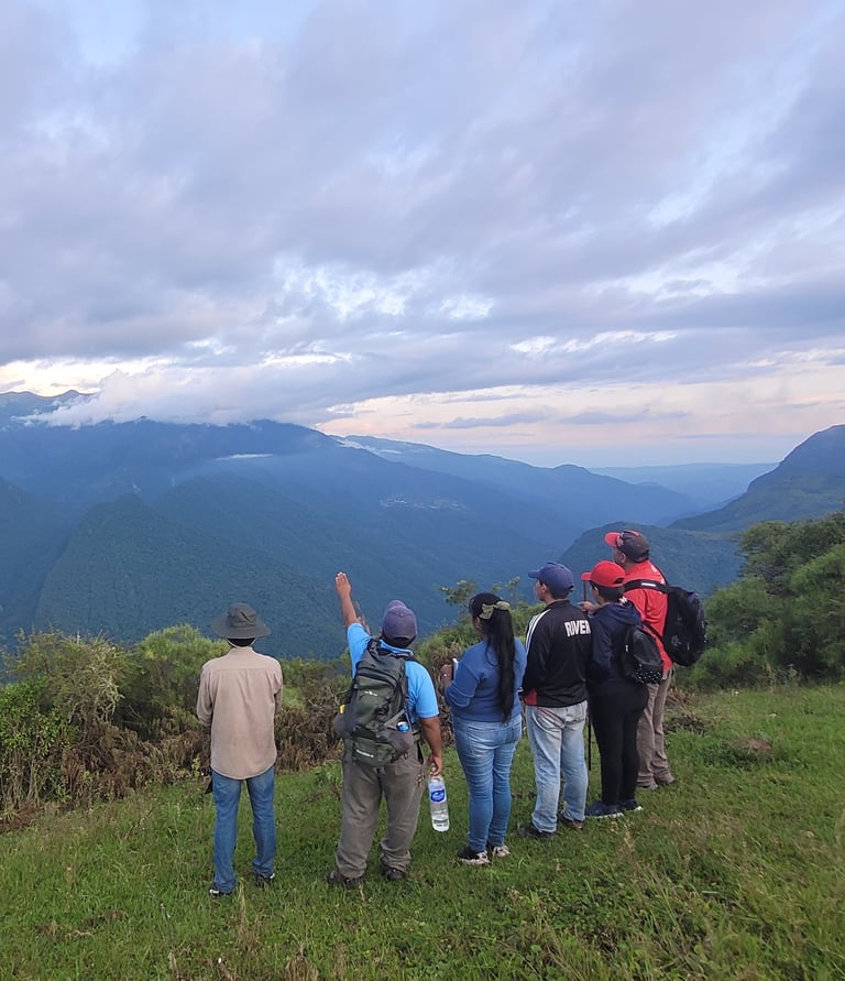 a group of people standing on a hill top