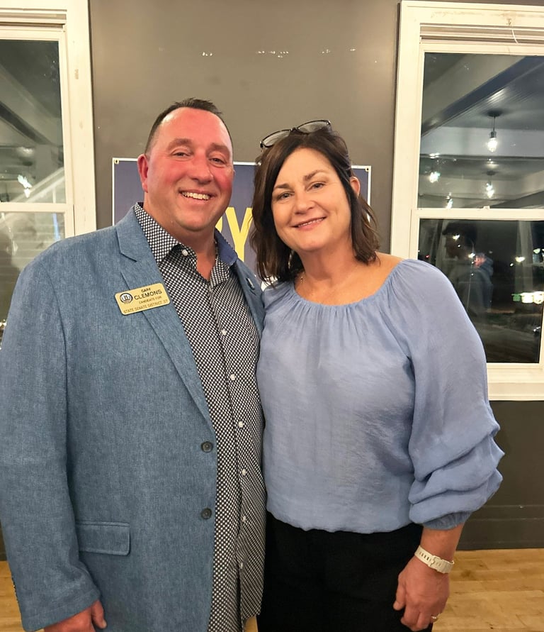 a man and woman standing in front of a window