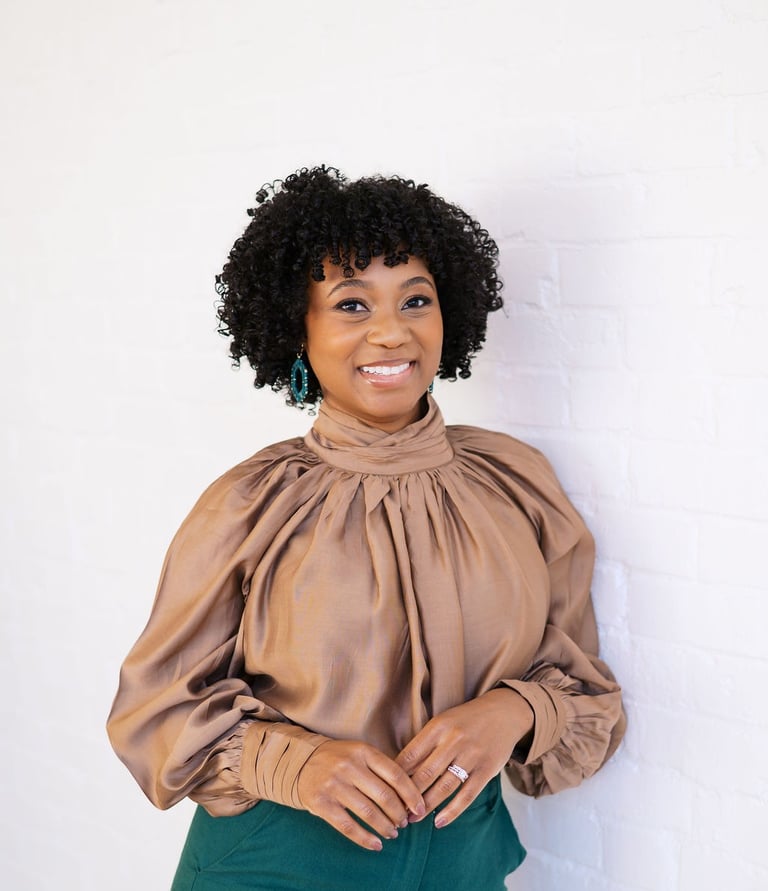 a woman in a brown blouse and green pants