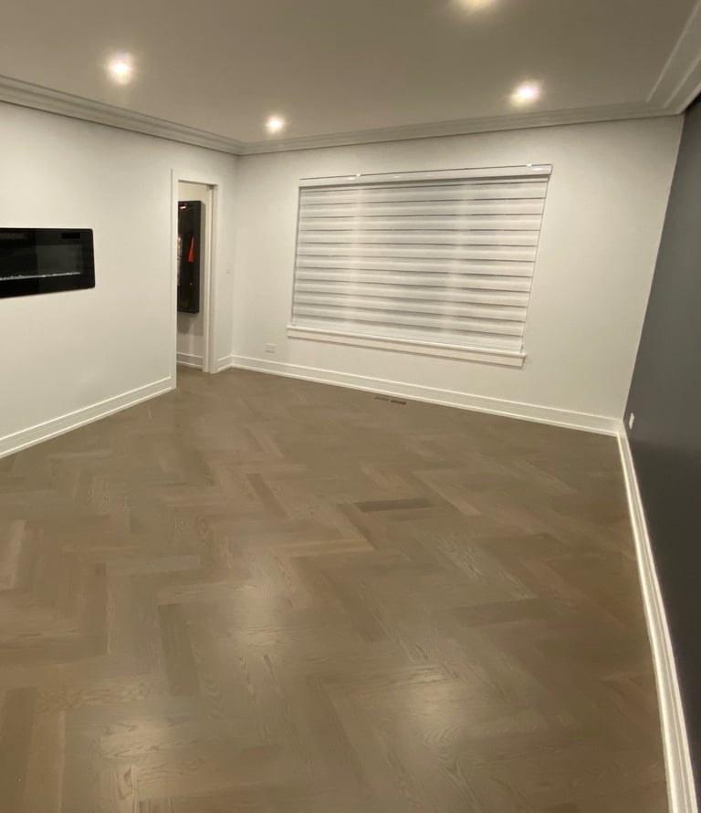 Custom herringbone hardwood flooring installation with modern fireplace in a Chicago North Shore home