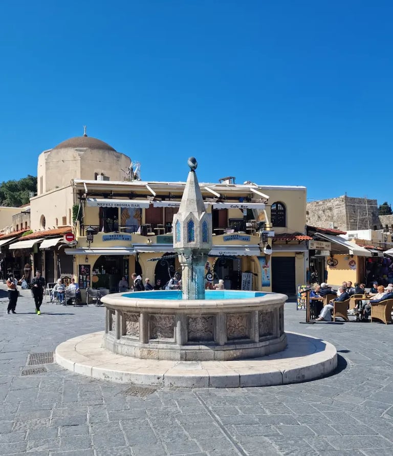 a fountain fountain in a square in a town