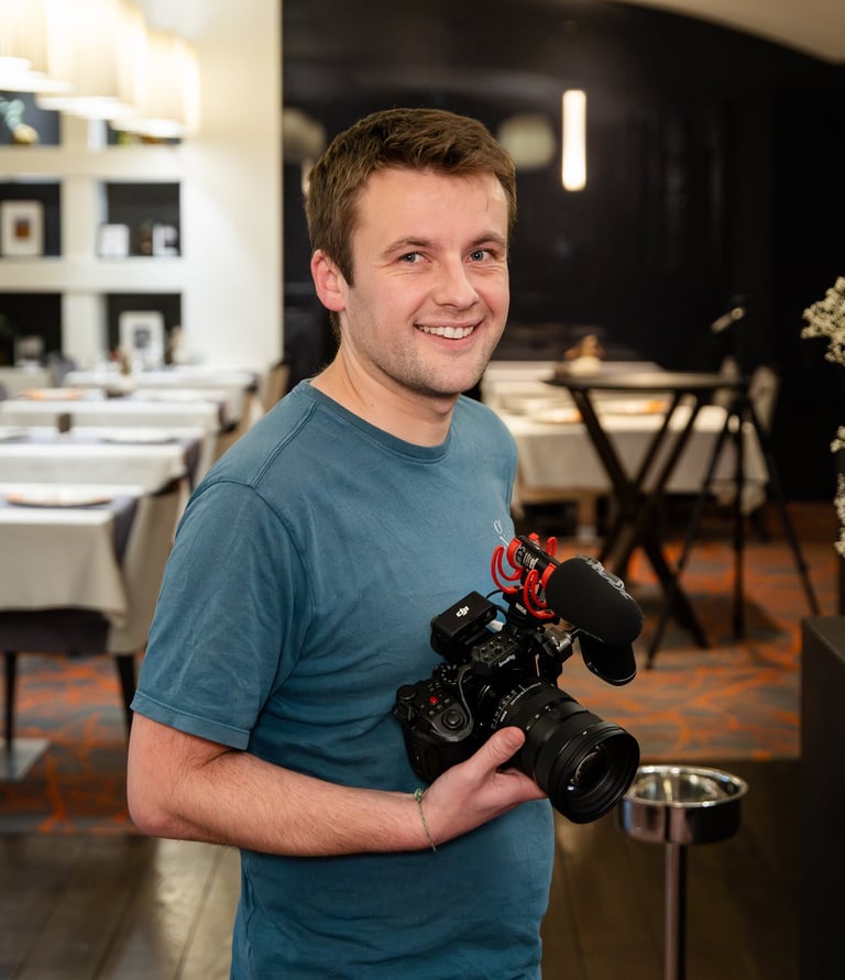 a man holding a camera and smiling
