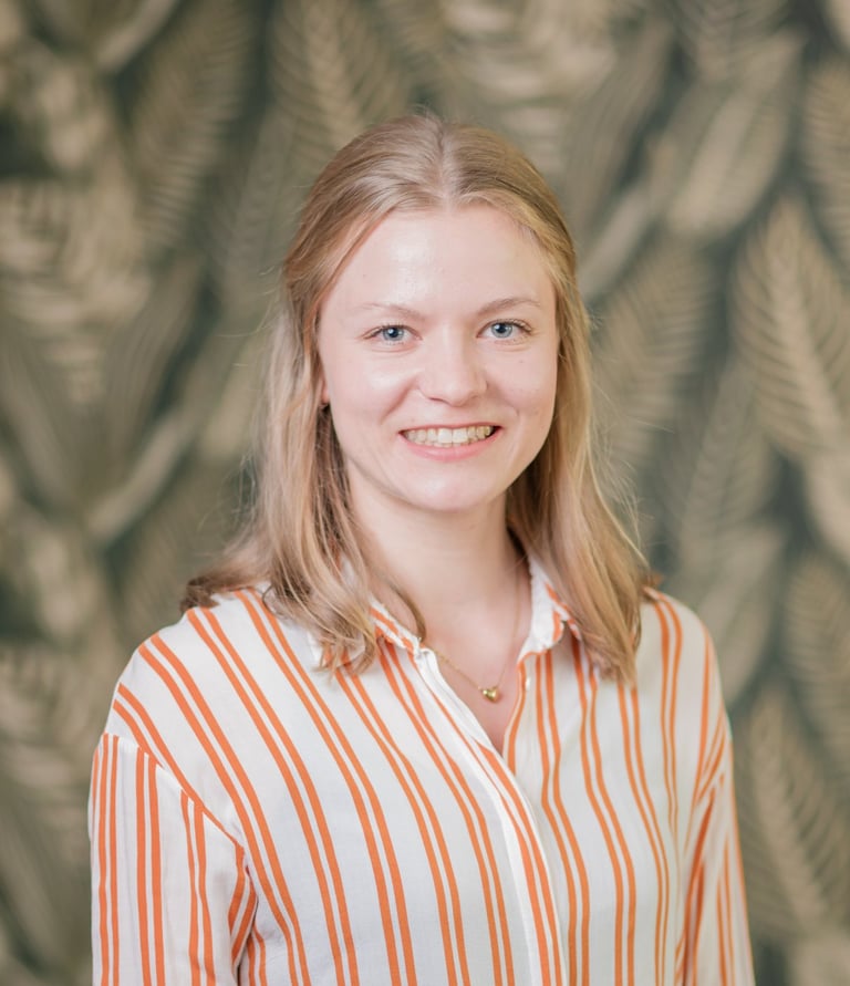 a woman in a striped shirt and jeans