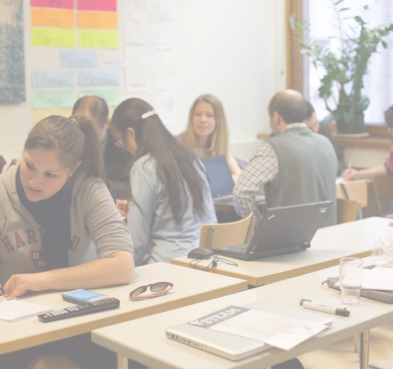 group of teachers at desks learning in a classroom