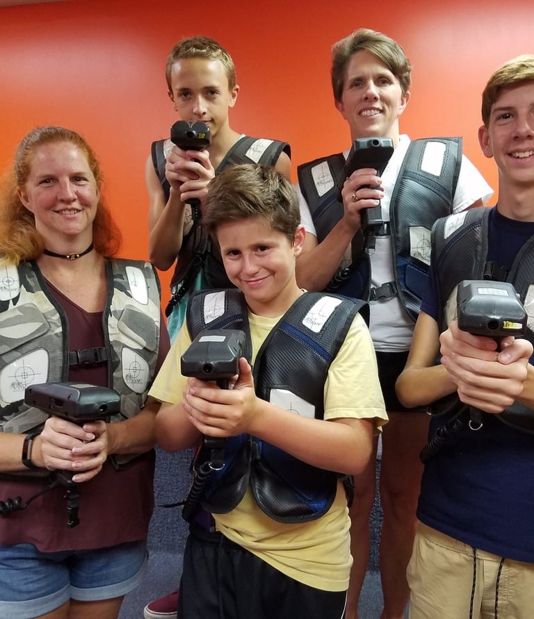 family posing for laser tag