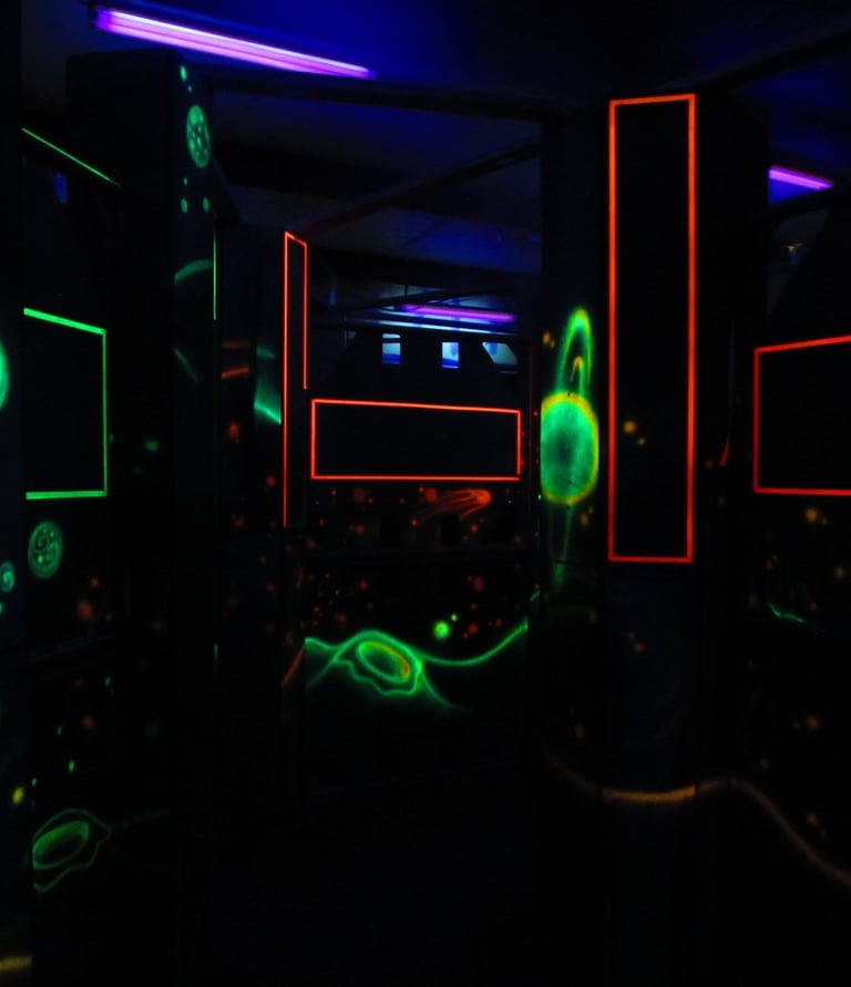 dark laser tag arena with glowing decorations