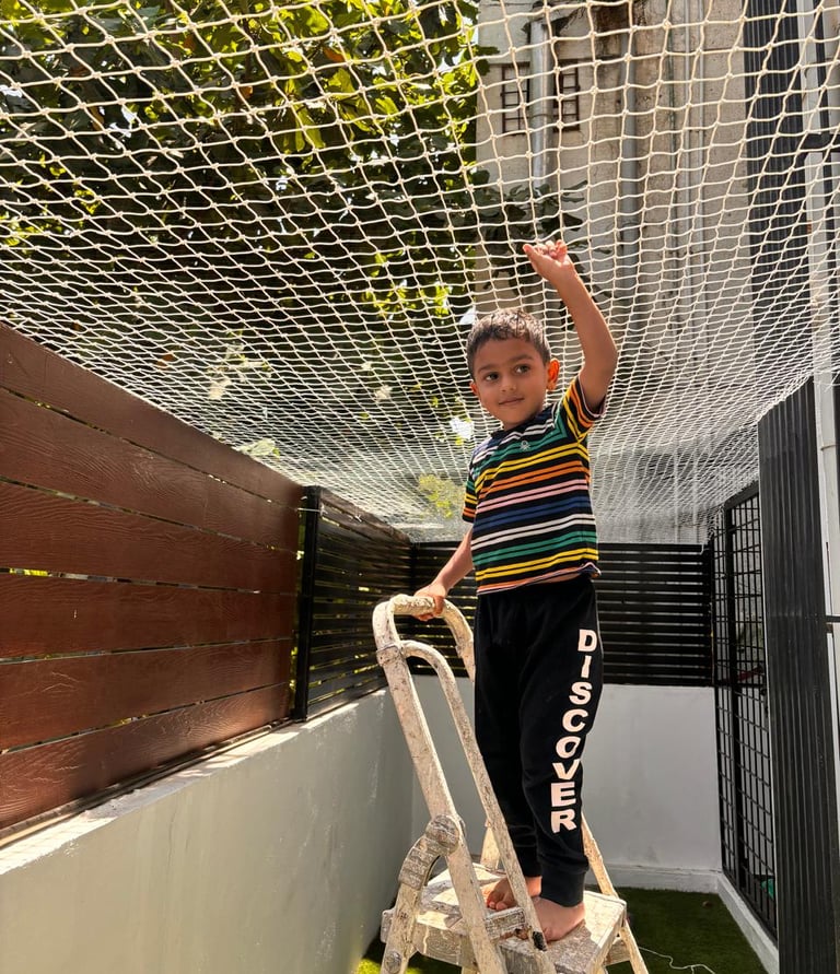 Wide shot of a high-rise apartment building on Altamount Road with pigeon nets installed on balconie