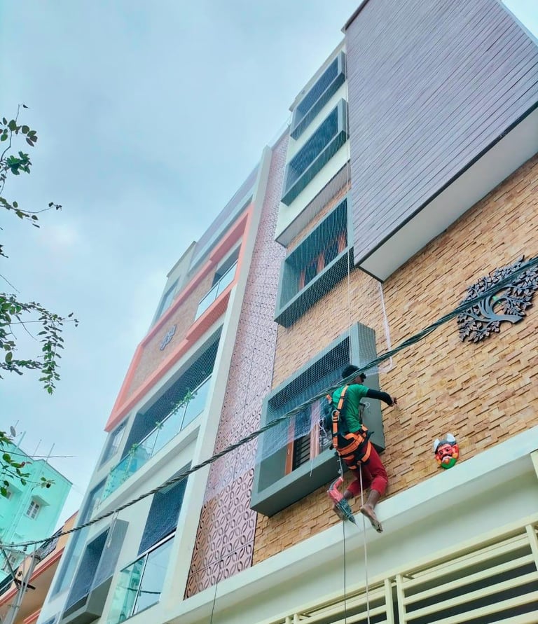 Close-up of a securely installed pigeon net on a balcony in a Chennai apartment.