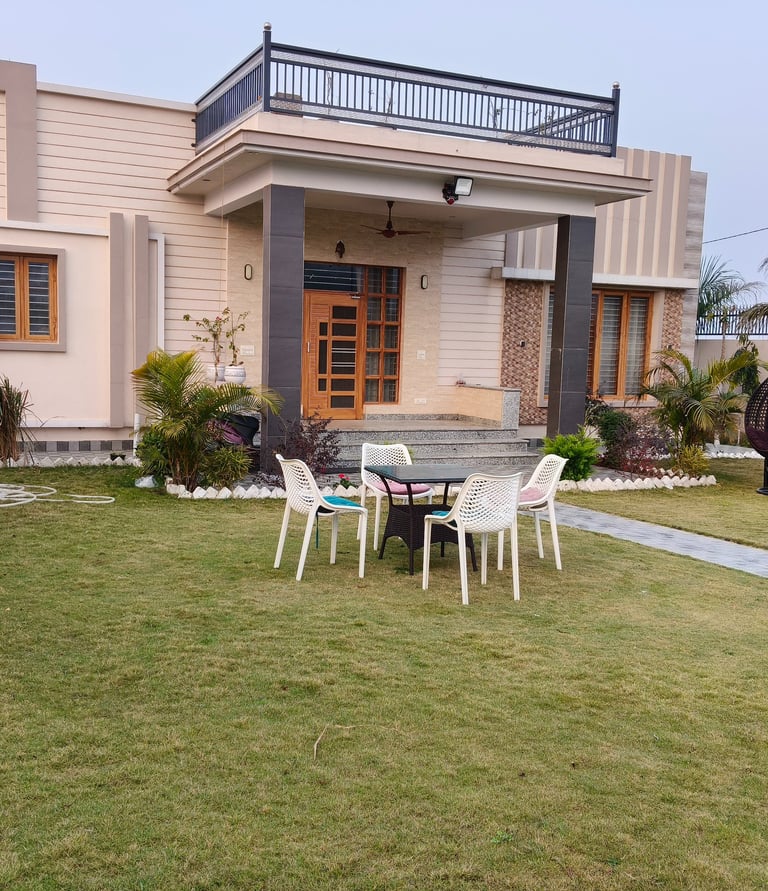 Modern luxury PG with a green lawn, outdoor patio furniture, and a balcony terrace.