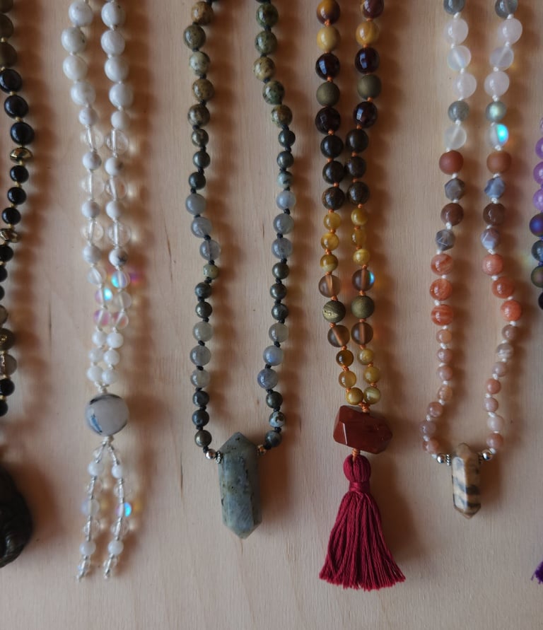 Hand-knotted gemstone mala necklace with 108 beads, created by Tina Marie Medina for spiritual meditation and energy healing