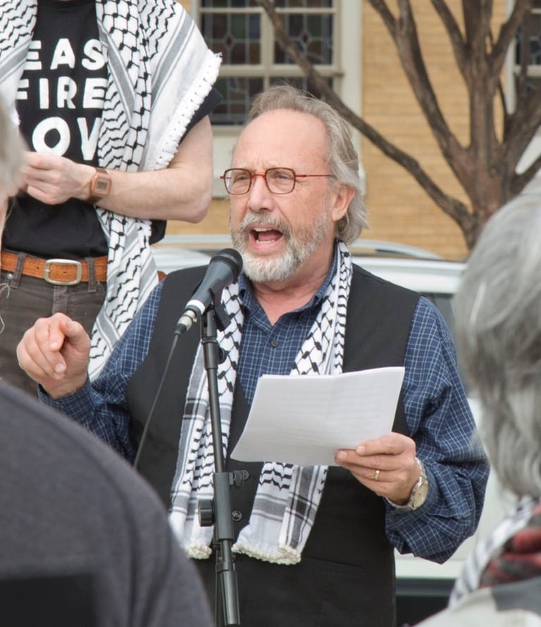 Mark Davidson addresses a crowd at an event for Palestine