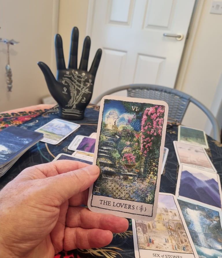 the lovers tarot card and a palm statue with the lines