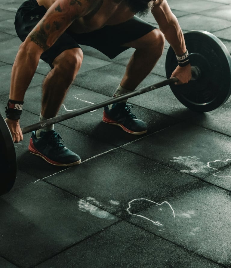 a man is squatting on a barbell