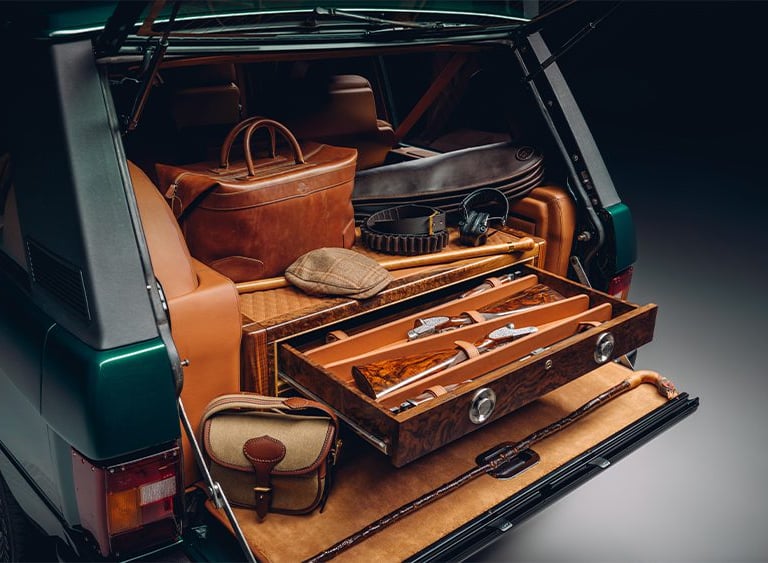 Range rover trunk open with drawers and hunting gear