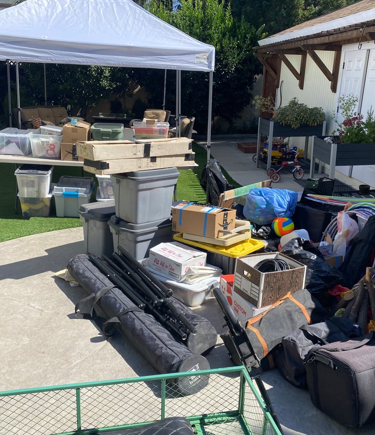 a pile of luggage and program supplies getting ready for camp