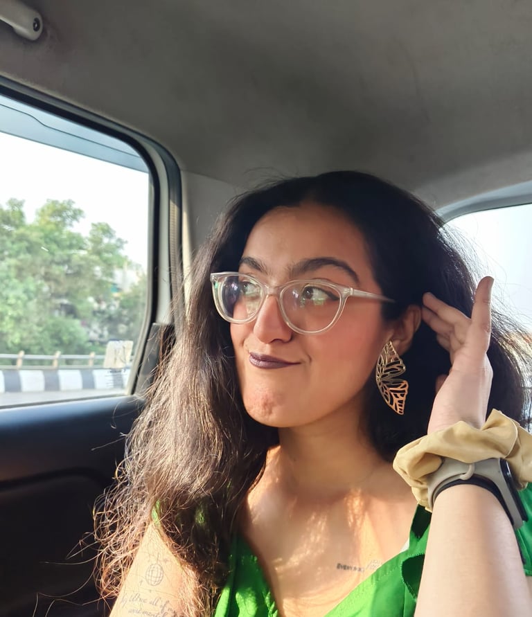 Riya, human copywriter posing in a car