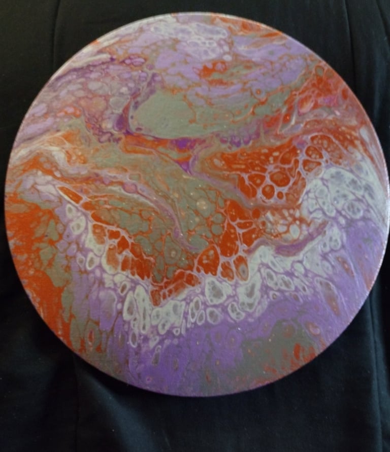 a colorful painted plate with a circular design