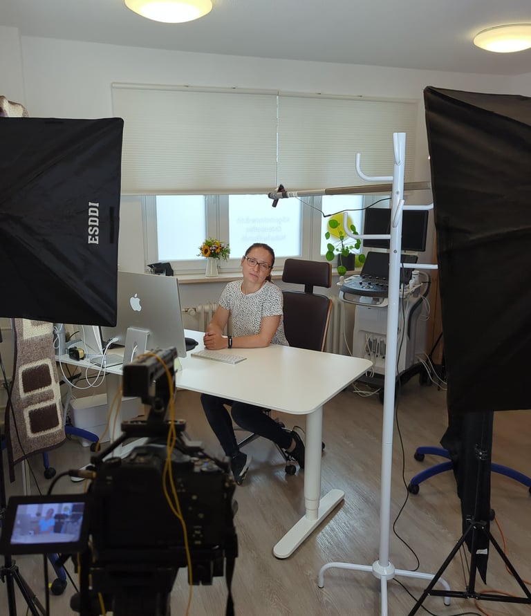 a man sitting at a desk with a camera and a camera