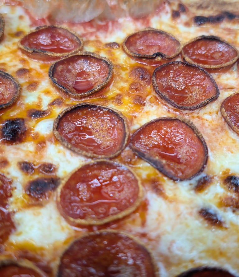 a perfectly cooked wood fire pizza with beautiful pepperoni
