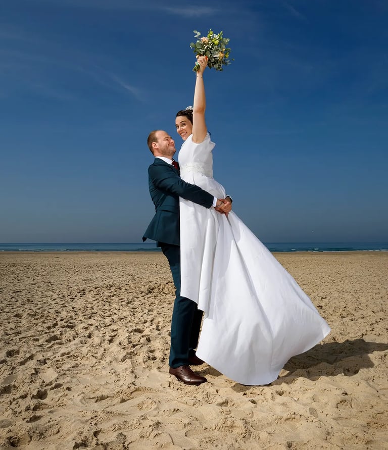 photographe mariage florent saint omer lille bride and groom are holding their hands up in the air 