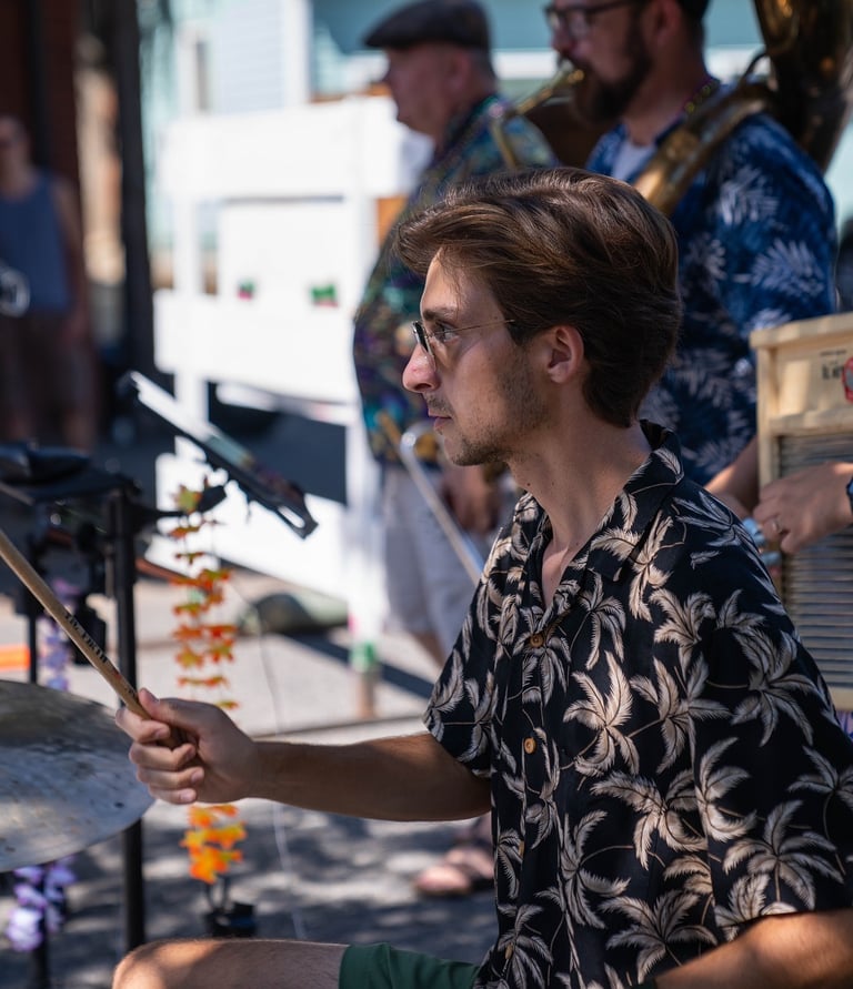 a man playing drums in a brass band, portland oregon, mardi gras, new orleans music