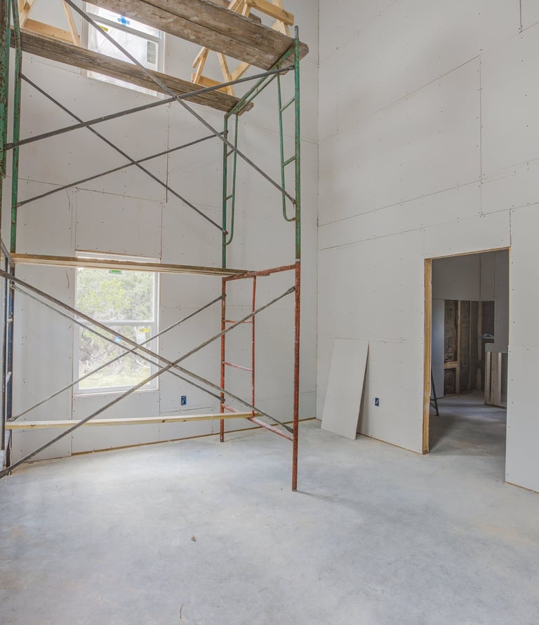 Unfinished primary bedroom with scaffolding during construction of Wimberley home