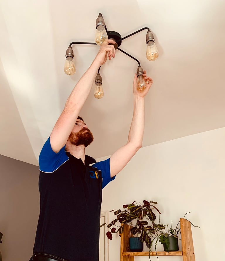 GigaVolt electrician installing a decorative light fitting