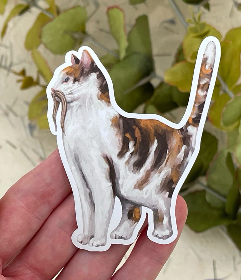 a sticker of a cat with a moustache sitting on a person's hand