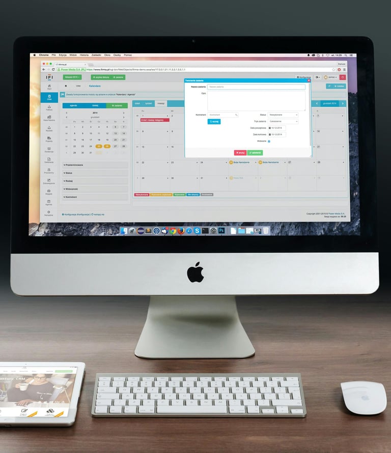 a computer monitor and a keyboard on a desk