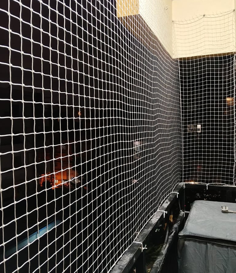 Close-up of a sturdy pigeon net installed on a balcony overlooking Altamount Road.