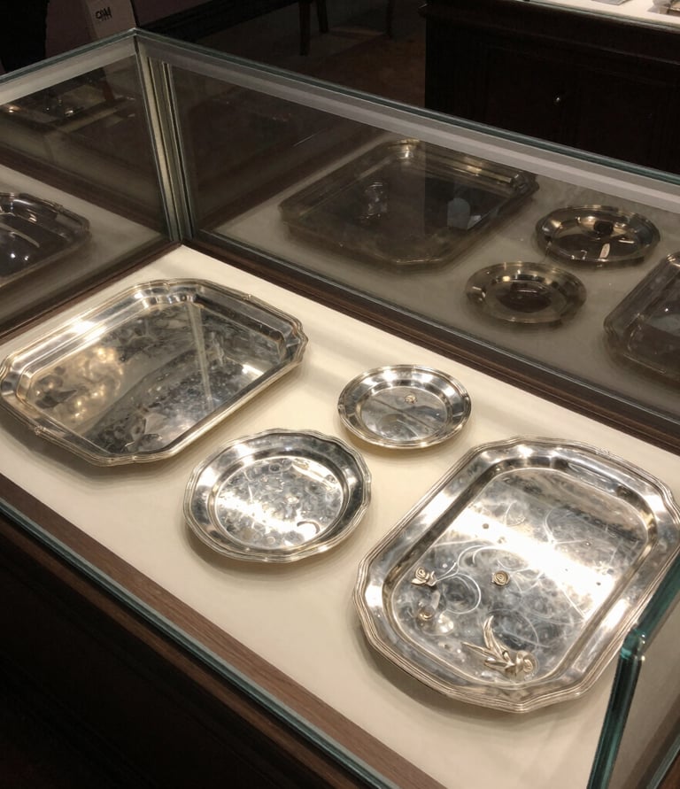 A skilled appraiser carefully examining a vintage silver necklace under bright light.
