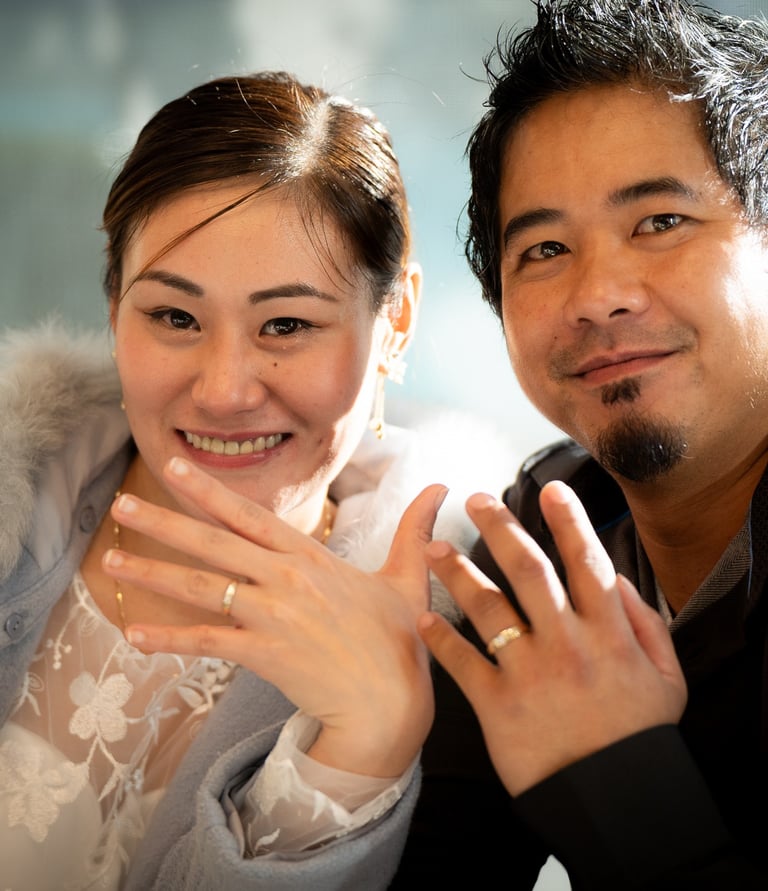 Wedding couple smiling and showing wedding rings