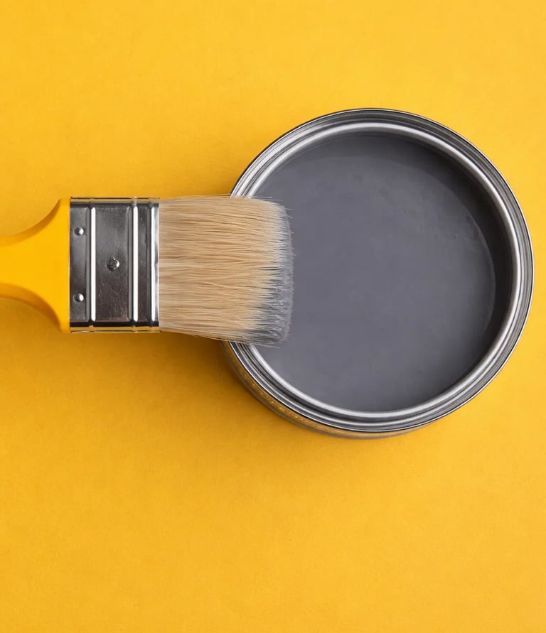 a paintbrush brush with a tin canister of paint