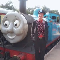  Cardiff magician Carl The Magician next to a blue Thomas the Tank Engine steam locomotive.